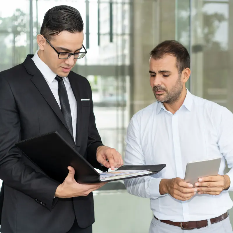 Professional auditor reviewing ISO certification documents in office environment